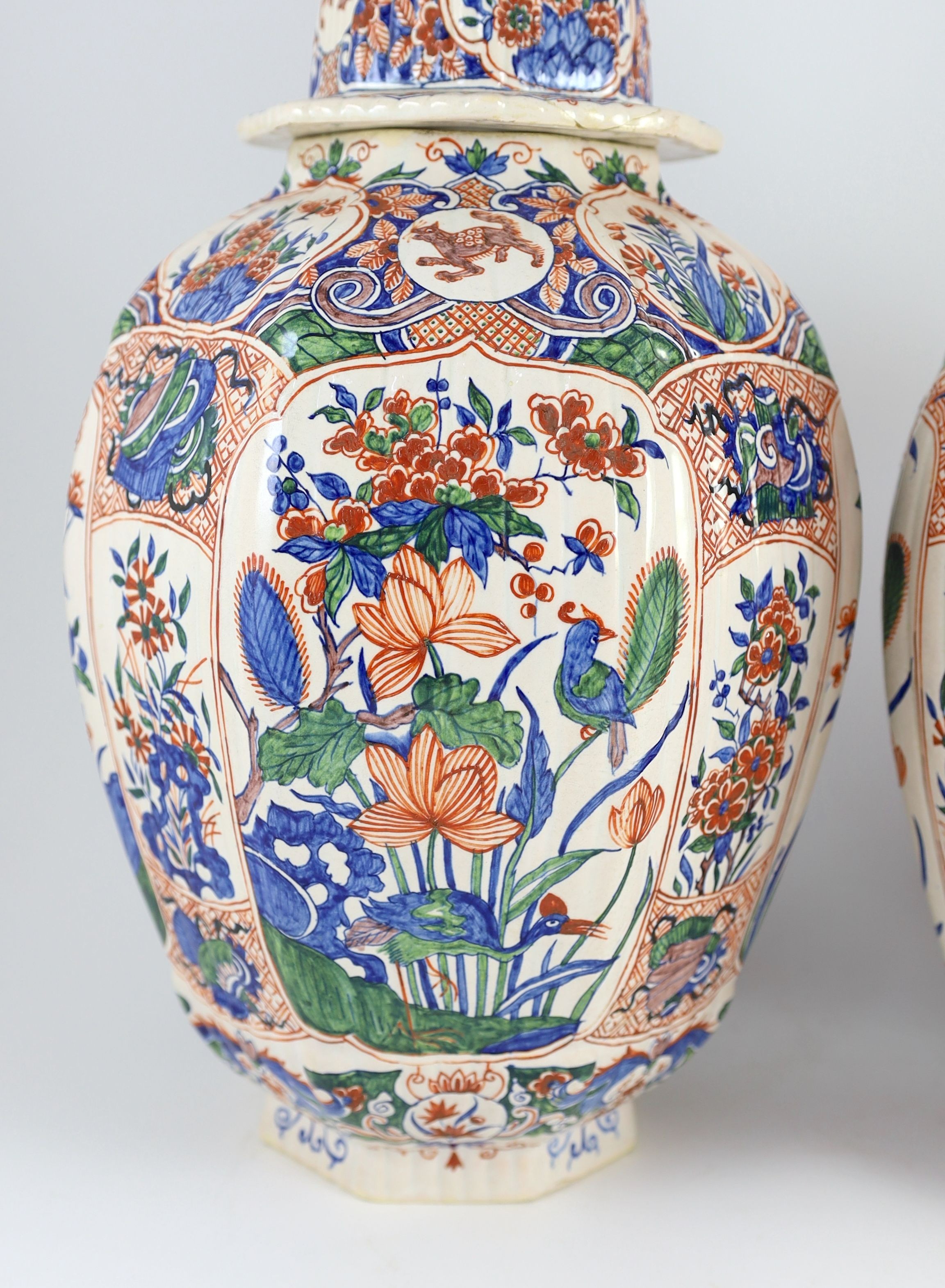 A pair of large Delft jars and covers, Pieter Kocx factory De Grieksche A, c.1701-1722, 50.5cm high, damage to covers